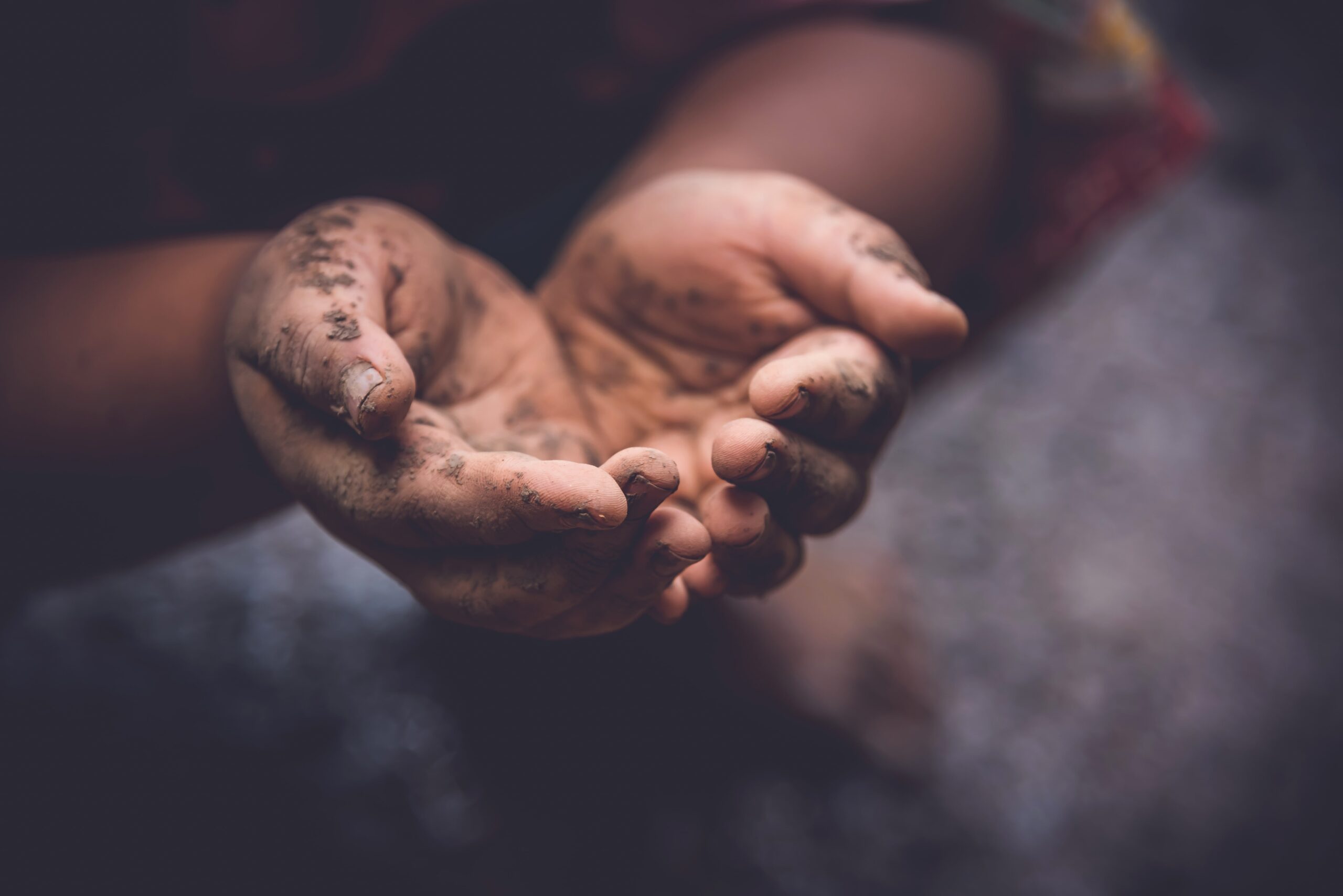 Hands of a person engaged in coercive cyberbegging, symbolizing online exploitation